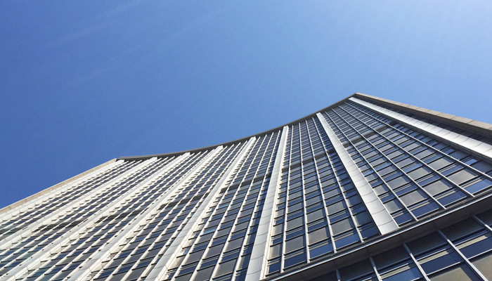 Chụp ảnh tòa nhà bất động sản thương mại với nền trời xanh ấn tượng